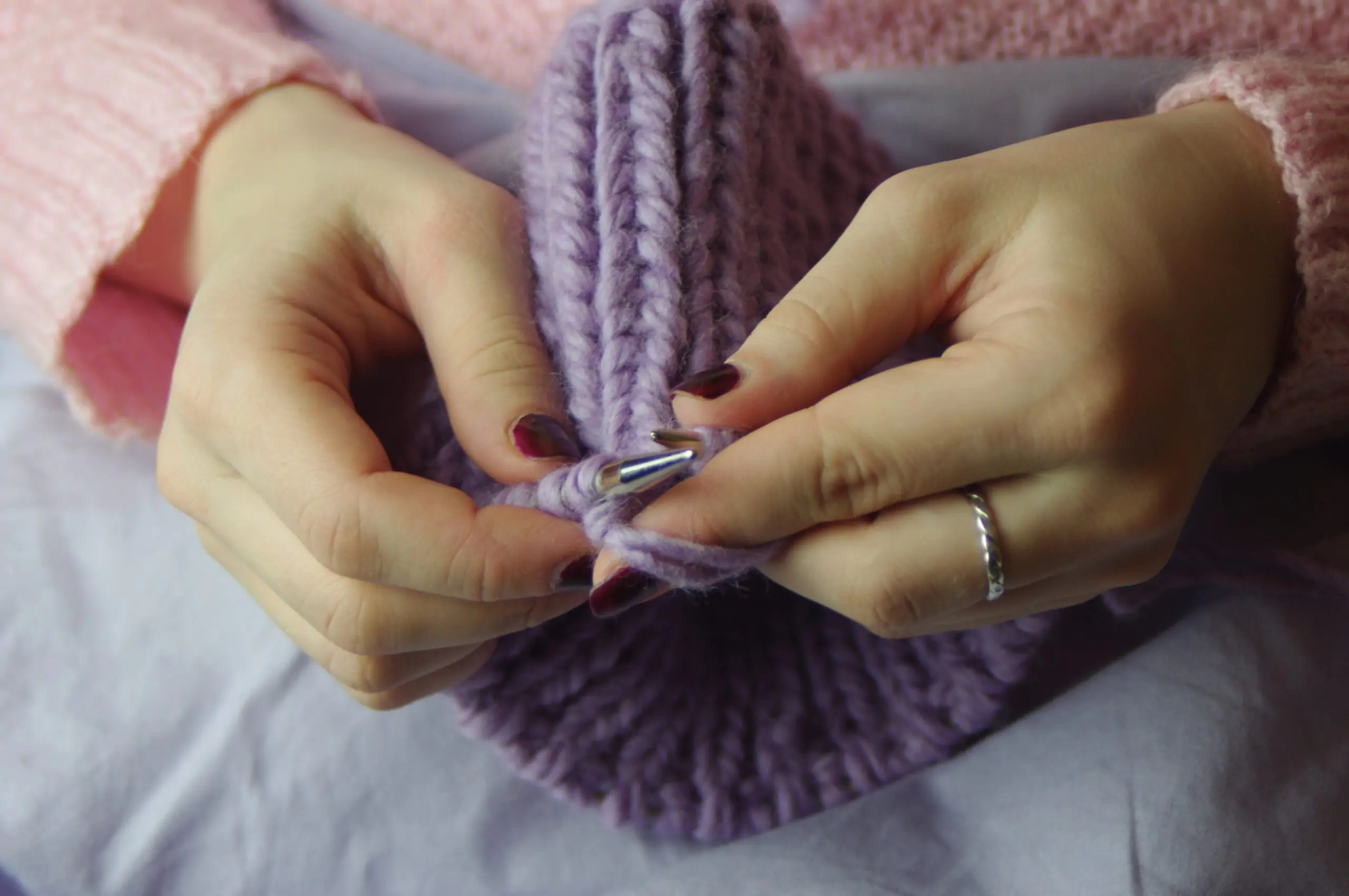 East Coast Telepsychiatry - 10 Great Ways to Improve Your Mental Health. Woman knitting with wool yarn for a hobby.