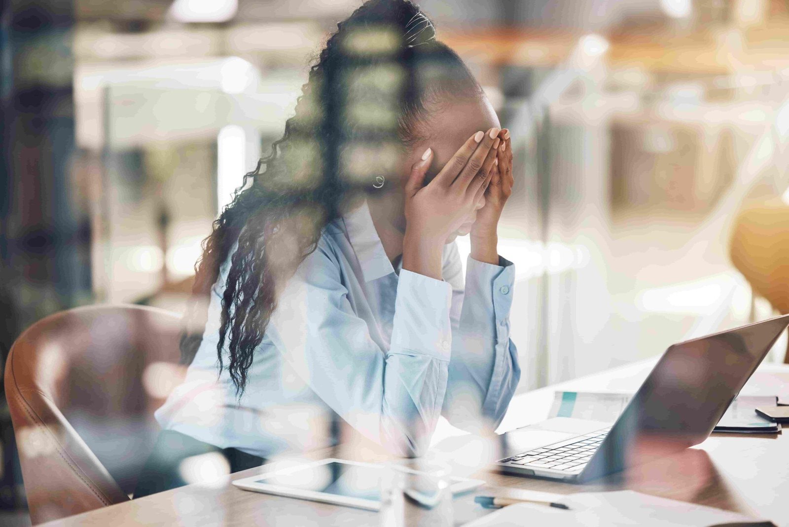 Mental Health in the Workplace -How Employers Can Promote a Healthier Environment - Business woman experiencing anxiety and stress at the workplace